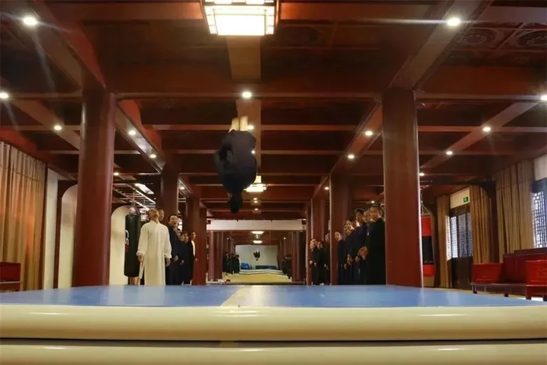 Teacher demonstrating Tai Chi posture indoors